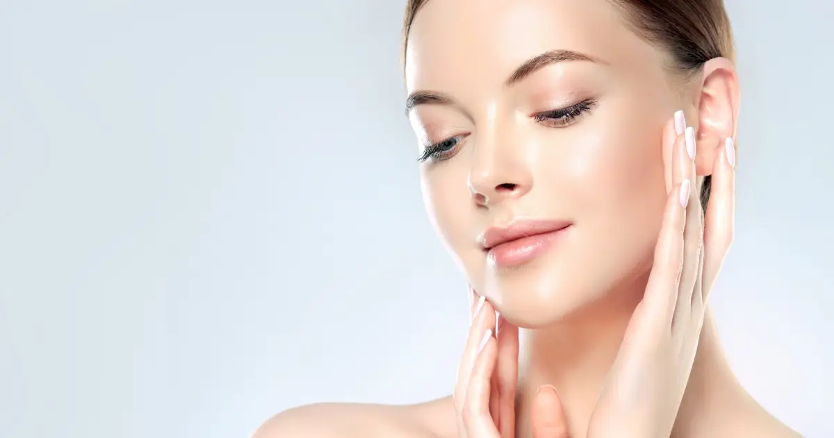 Woman showcasing clear, glowing skin after chemical peel treatment in Royal Oak, MI